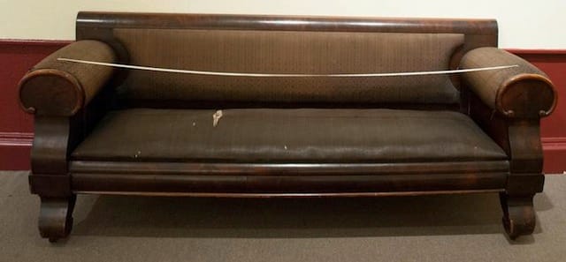 The couch prior to the start of its restoration