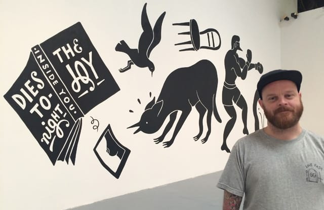 Curator Shannon Michael Cane with Farra's mural inside MOCA's Geffen Center, where the LAABF is taking place.