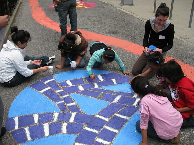  Brooklyn-based muralist Ellie Balk collaborated with art teacher Leslie Elvin and her students to design a colorful abstract map with a striped path that meanders through circle mandalas and reflects drawings made by the students after learning about street safety. (photo via NYC Dept. of Transportation's Flickrstream)