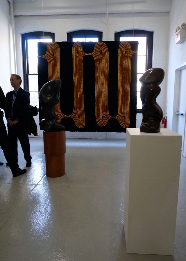 Two sculptures by Hans Arp in front of Enrico David's "Untitled Tapestry (Hornet's Nest)" (2013)