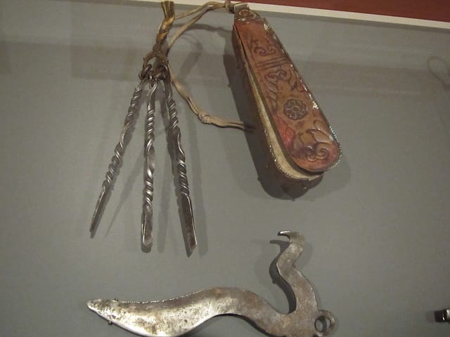 Set of bloodletting instruments with container (20th century), silver, Tibet; Surgical instrument (early 20th century), metal alloy, Central Tibet