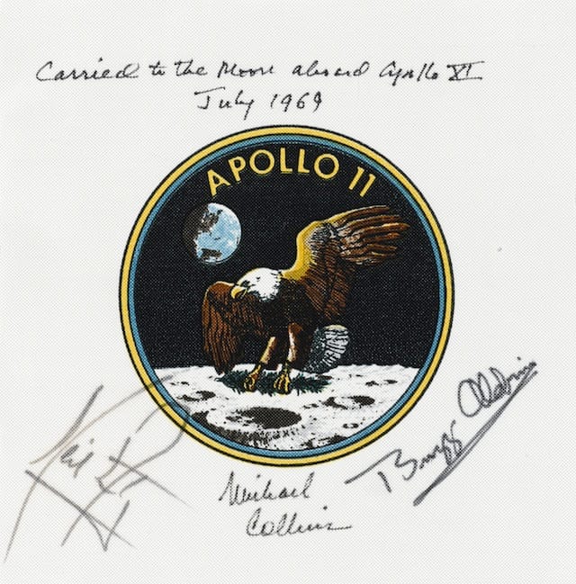 COLLINS' FLOWN CREW-SIGNED APOLLO 11 EMBLEM.  Flown Apollo 11 crew mission emblem, 3½ inches in diameter, printed on Beta cloth, 6 inches square.  Est. $40,000-60,000 