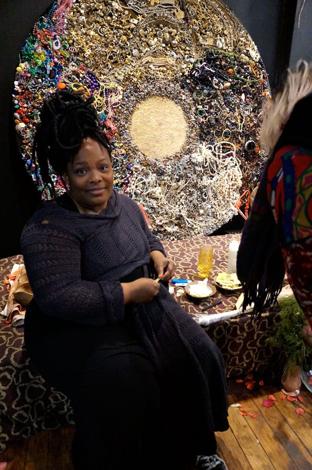 Artist Christa Bell on the edge of the stage where she chanted