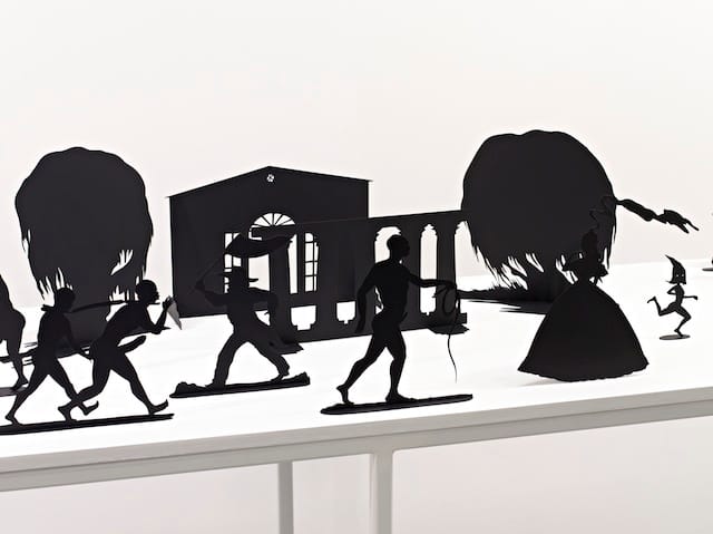 Kara Walker, "Burning African Village Play Set with Big House and Lynching," (2006). Painted laser-cut steel, sizes vary; table dims: 38 1/4 x 90 x 24."