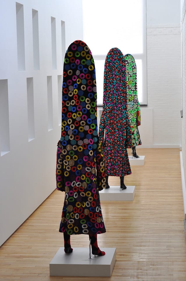 Some of Nick Cave Soundsuits from 2012 stand in the perimeter gallery of The School. (all photos by the author for Hyperallergic)