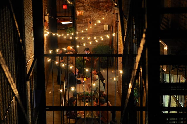 People gathering for a drive in the alley beside 195 Morgan Ave, where the Do It Yourself and Mixtape! group shows are taking place during the 2014 Bushwick Open Studios. (all images by the author for Hyperallergic)
