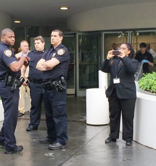 A Guggenheim security guard videoing protesters. (photo Hrag Vartanian/Hyperallergic) (click to enlarge)