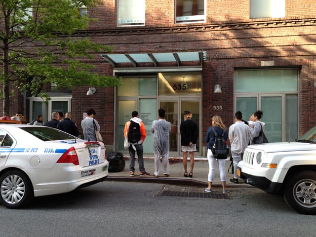 The scene, including police car on left and security SUV on right