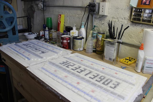 Two finished Chicago-themed mosaics waiting for potholes