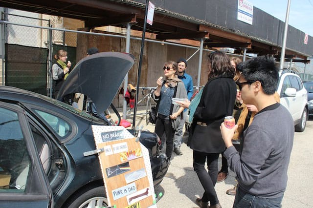 A guest at Trunk Show's April opening admires past bumper stickers.