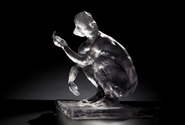 Eric Fischl, "Squatting Woman with Arm Raised" (2012), cast glass, 21 x 19 x 18 in. (via kmfinearts.com)