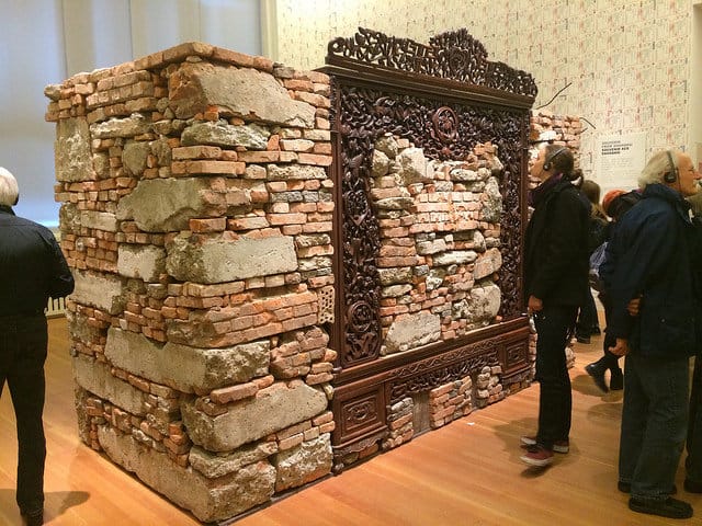 Ai Weiwei, "Souvenir from Shanghai" (2012), concrete and brick rubble from Ai Weiwei's destroyed Shanghai studio, rosewood bedframe from Qing Dynasty (1644–1911)