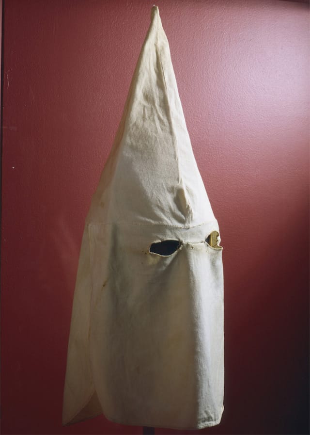 Hood, Ku Klux Klan, 1920s Woman’s KKK march Vermont Historical Society 1993.16 "The Ku Klux Klan, organized in 1866, spread rapidly as a means of maintaining white dominance during Reconstruction. A robe and hood disguised the perpetrators of acts of terrorism, keeping them safe from identification and prosecution. Federal intervention suppressed the Klan after about 1873. In 1915, the Klan was revived in reaction to increased immigration into the United States by Catholics and Jews from southern and eastern Europe. This hood from from Vermont, and marks the admittance of women into the KKK."