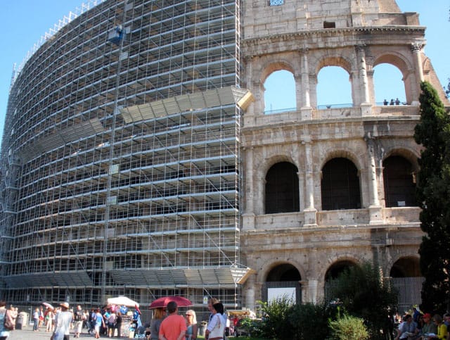 The Colosseum covered in scaffolding last fall as part of its restoration, which was funded by luxury company Tod's. (photo by Jillian Steinhauer/Hyperallergic)