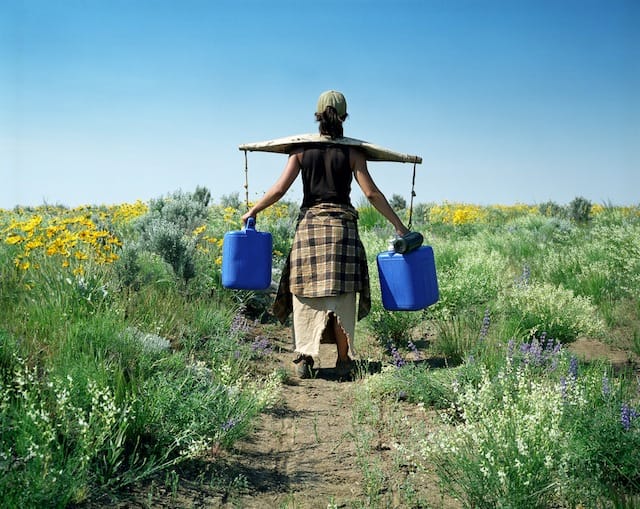 carrying water Huddles Holes, Crater of the Moon, Idaho 