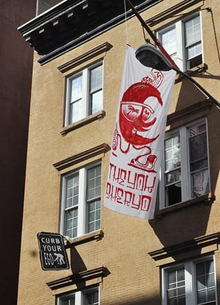 Works by Curb Your Ego and Sheryo & The Yok hang on the facade of the 21st Precinct. (click to enlarge)