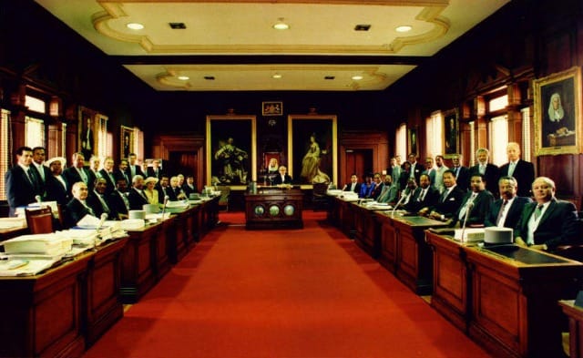 The Bermuda House of Assembly, with the paintings of King George III & Queen Charlotte Sophia in the background (via bermuda-online.org)