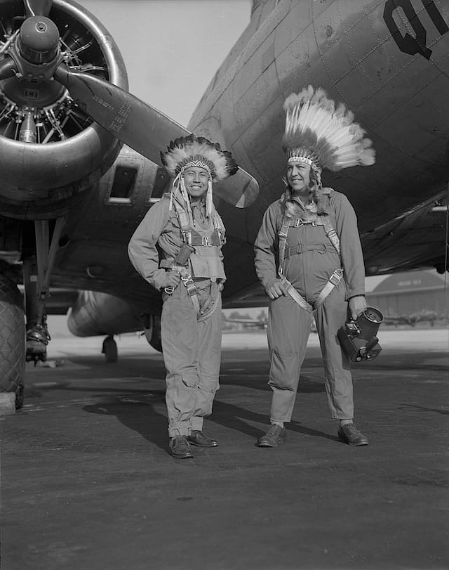 Caption: Gus Palmer (Kiowa, at left), side gunner, and Horace Poolaw (Kiowa), aerial photographer, in front of a B-17 Flying Fortress. MacDill Field, Tampa, Florida, ca. 1944. 45UFL14
