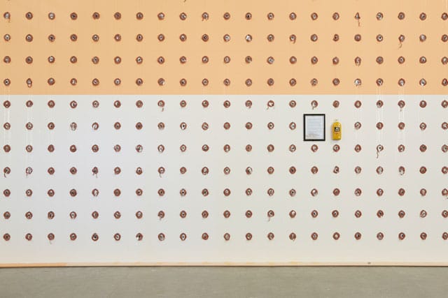 William Pope.L, "Claim" (detail) (2014), wall, paint, pencil, 688 slices of baloney, and 688 black and white photocopy portraits of citizens taken randomly on the streets of Philadelphia purportedly equaling 1% of the total number of Jewish people in the city