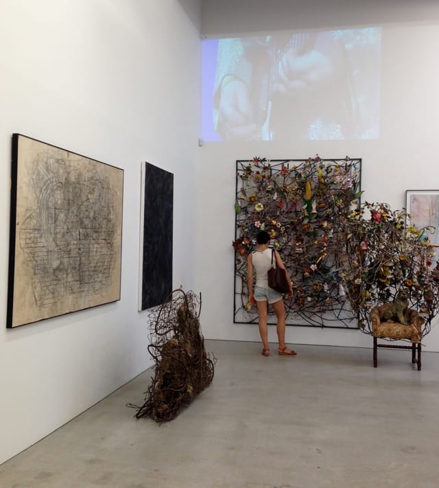 Installation view, 'Another Look at Detroit' at Marlborough Chelsea, with MC5 video hovering over a corner of artworks with messy clusters of lines