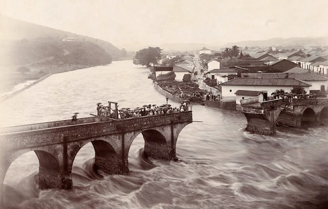 Water collapses Tegucigalpa’s arched bridge in Honduras (August 1916) (photograph by F. J. Youngblood, National Geographic)