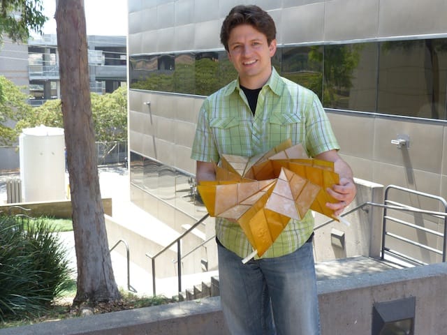 Brian Trease with the solar panel array prototype (photograph courtesy NASA/JPL-Caltech)