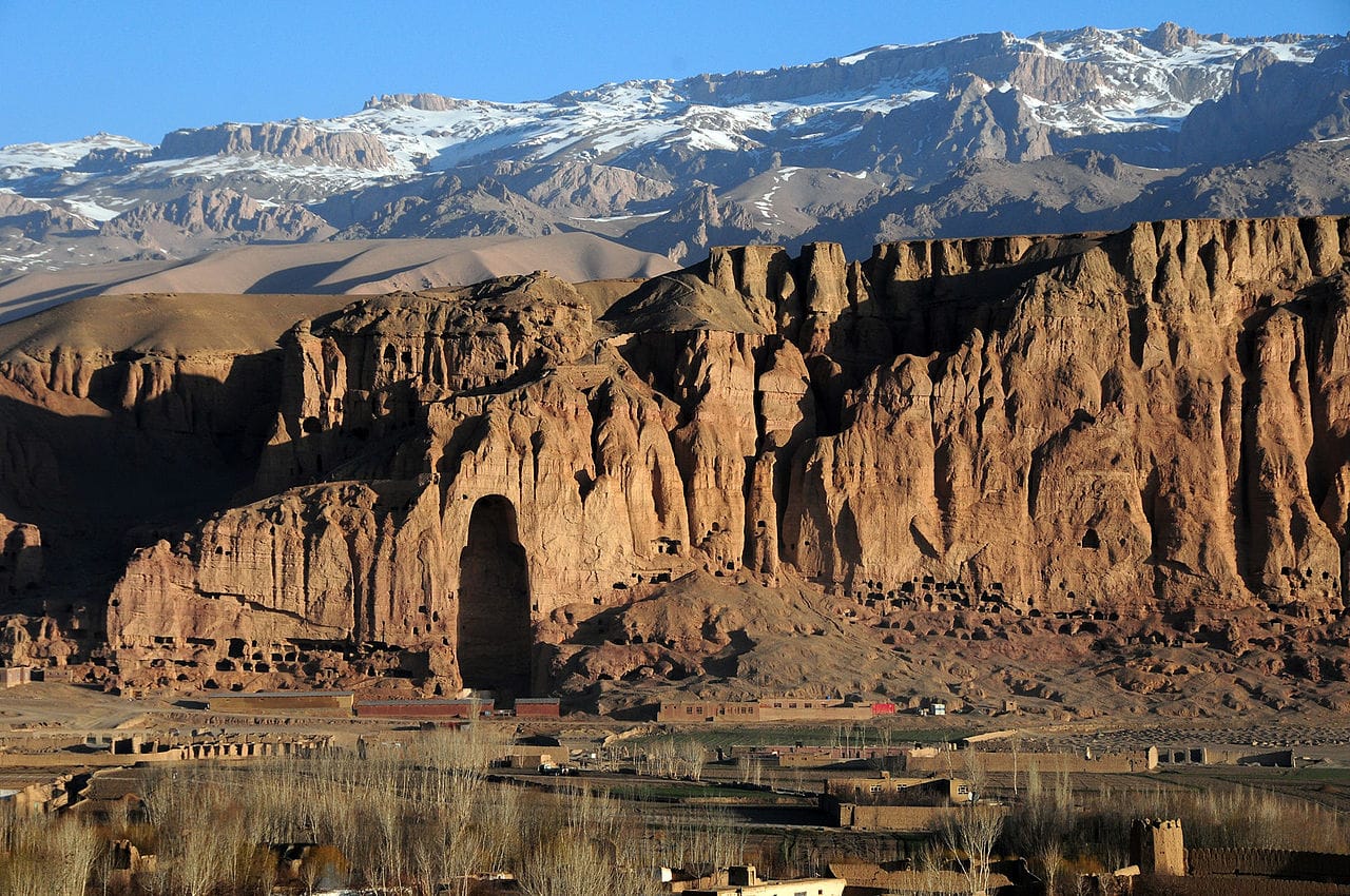 Bamiyan Valley in 2010, with the hole where one of the Buddha statues was demolished (photograph by Afghanistan Matters, via Wikimedia)
