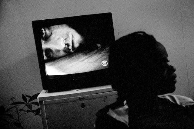 Alexandra Hobbes was blinded by domestic violence at age 4. Her husband Elijah is also visually impaired. Here, she listens to her television.