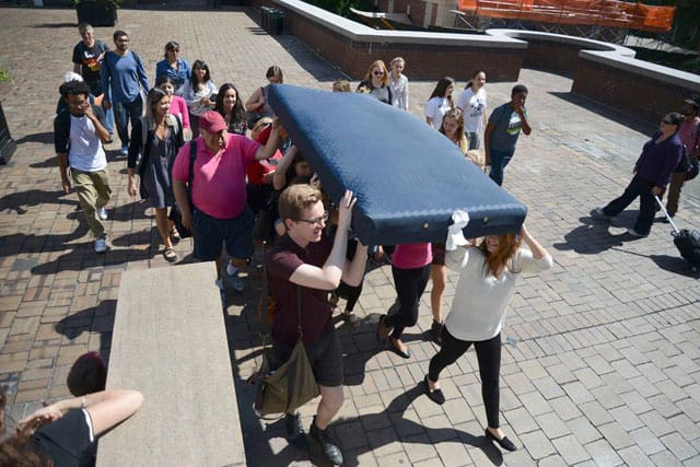 Fellow students organized by Carrying the Weight Together carrying the mattress for Emma Sulkowicz (photo via Carrying the Weight Together/Facebook) (click to enlarge)