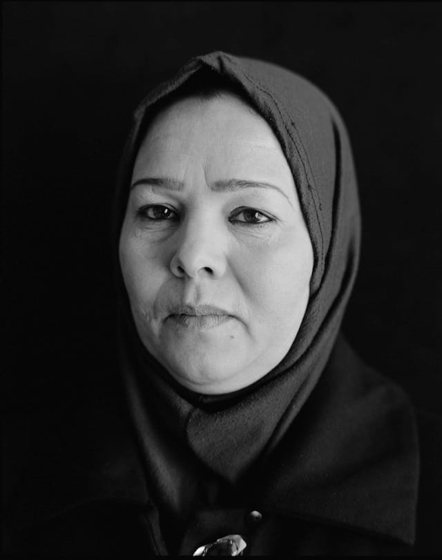 This woman was detained by the U.S. government from January to July of 2004. "They put me in a room and they put my son in a cage in front of me," she said. A soldier told her, "Confess that you know terrorists or I will send you to a place where they will rape you. They will do things to you that you could never imagine." She was freed without charges.