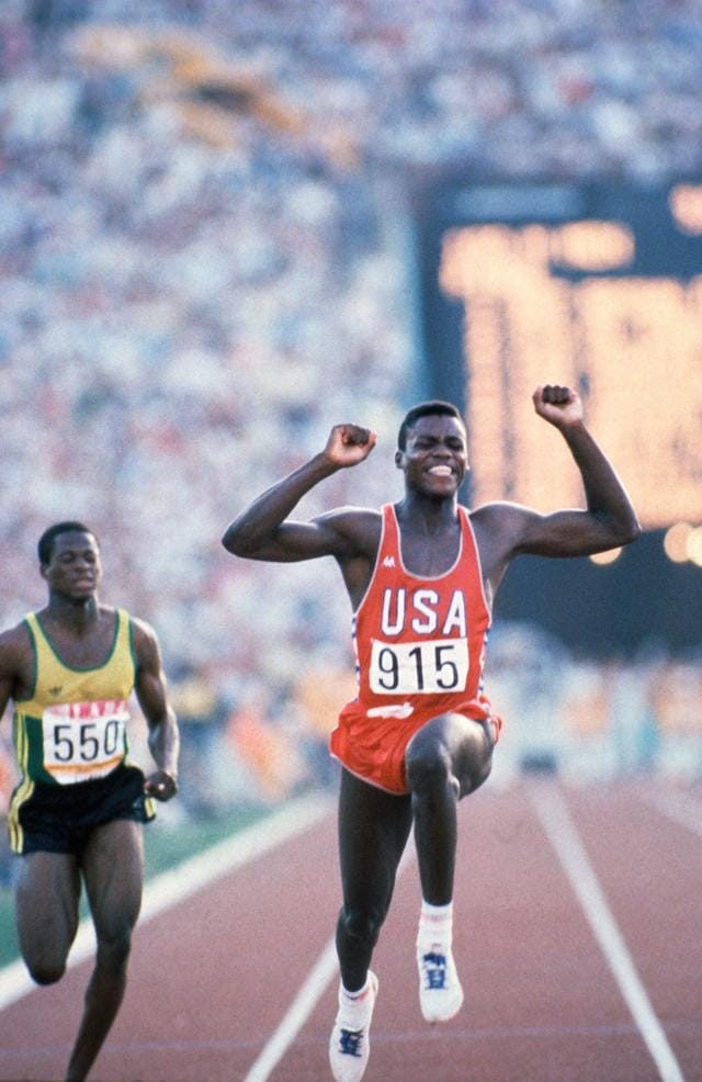 Carl Lewis, who won four gold medals at the LA Olympcs in 100m, 200m, 4 x 100m relay, & long jump (￼￼Los Angeles 1984 OG, Athletics, 100m Men - Final, Carl LEWIS (USA) 1st wins. Ray STEWART (JAM).