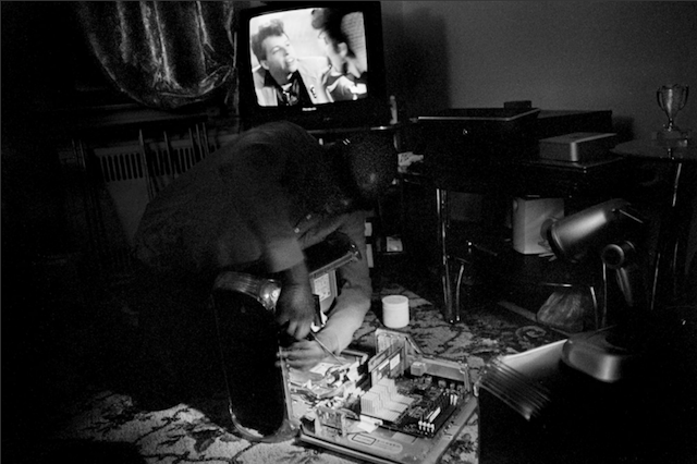 Dale Layne repairs a computer at his home in Brooklyn. (All images courtesy of Gaia Squarci) 