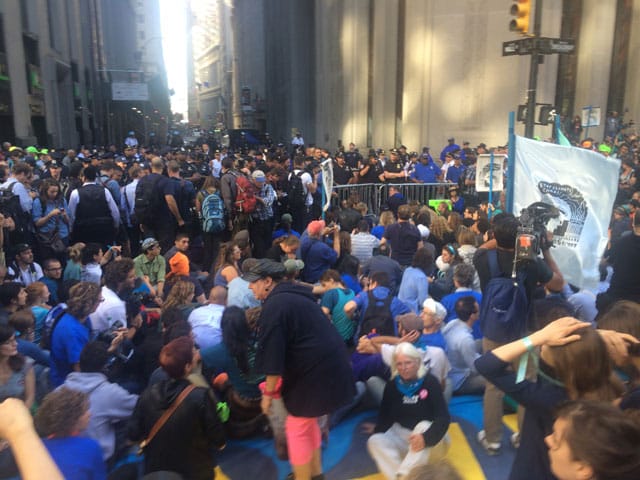 Protesters sitting at the corner of Broadway and Wall St. (photo by Hrag Vartanian/Hyperallergic)
