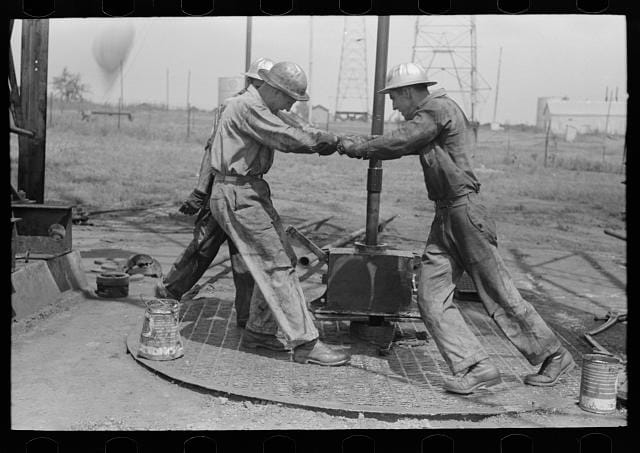 Roughnecks tighening a pipe on an oil well, Oklahoma City, photograph by Russell Lee (August 1939) (via Photogrammar/Library of Congress)