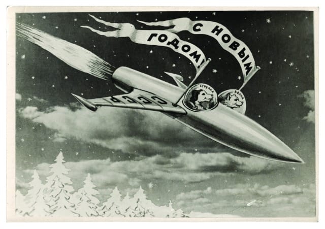 BELKA STRELKA MONTAGE POSTCARD.jpg Postcard, USSR (1960) A postcard showing Belka and Strelka in their rocket by the photomontage artist Sveshnikov. The flags read ‘Happy New Year’, on the wing of the rocket ‘USSR’, inside the cockpits ‘Strelka’, and ‘Belka’. © FUEL Publishing 