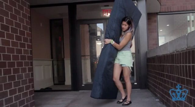Emma Sulkowicz performing "Mattress Performance" or "Carry That Weight" (screenshot via YouTube)