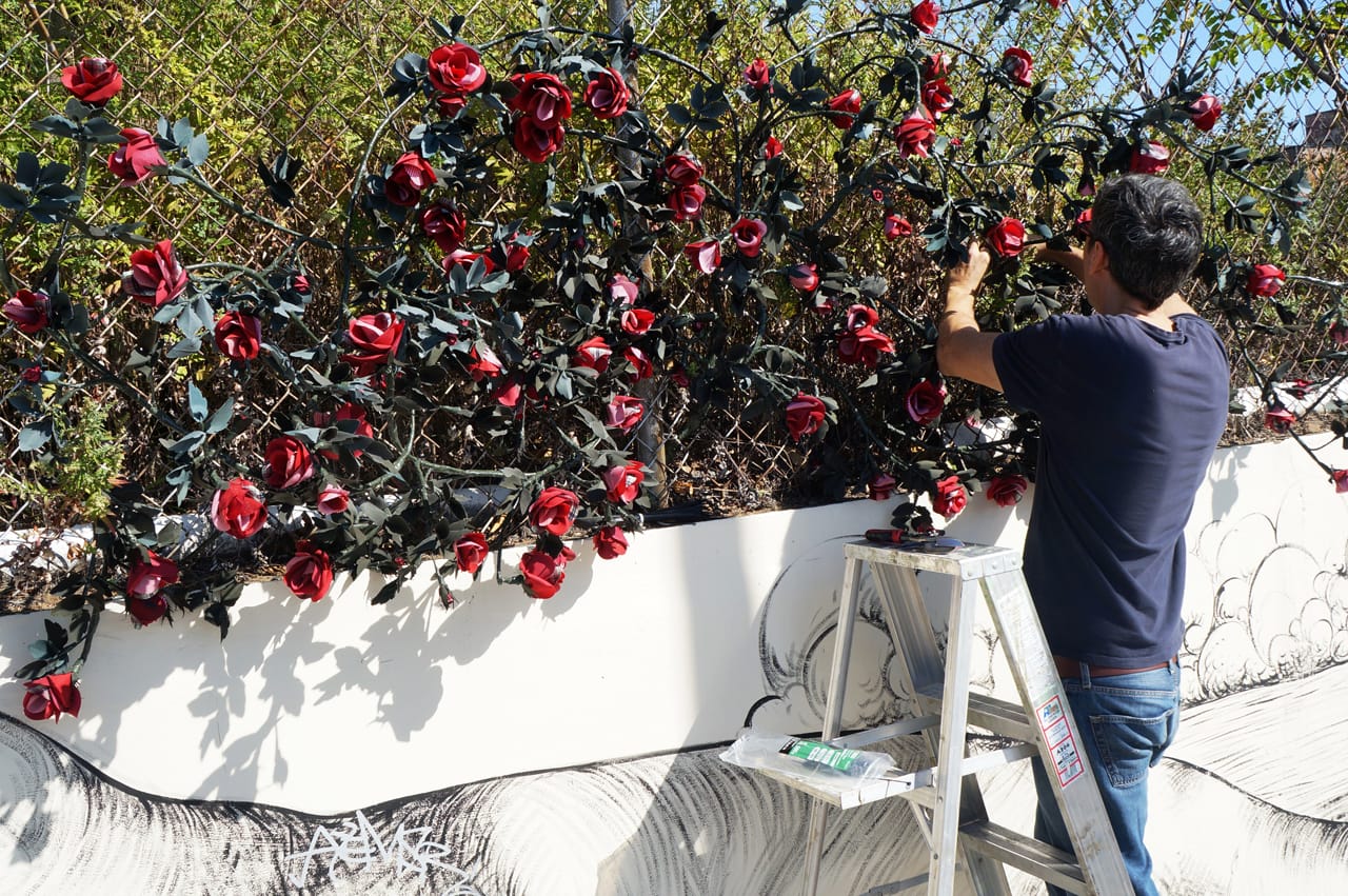 Carlton Scott Sturgill installing "Bridge of Flowers" (photo courtesy Arts Gowanus)