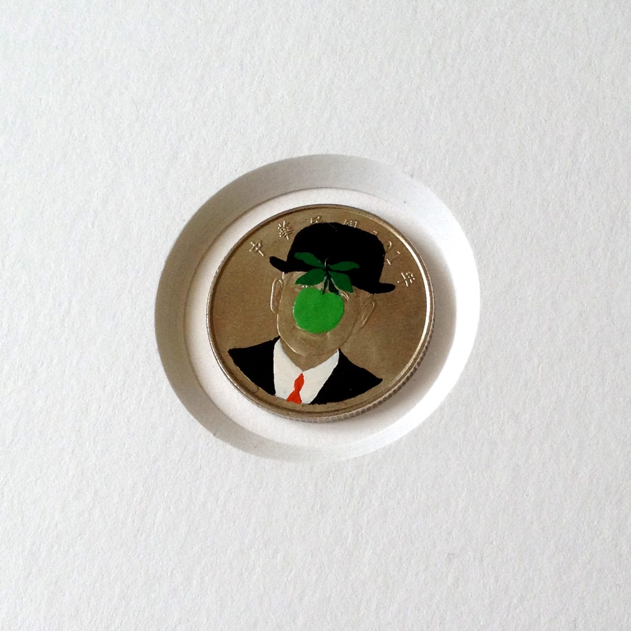 Andre Levy coin painting of René Magritte's "The Son of Man"