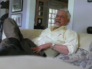 David Boxer, the retired, former director and chief curator of the National Gallery of Jamaica, at his art-filled home in Kingston, Jamaica, September 2014 (Photo by the author for Hyperallergic)