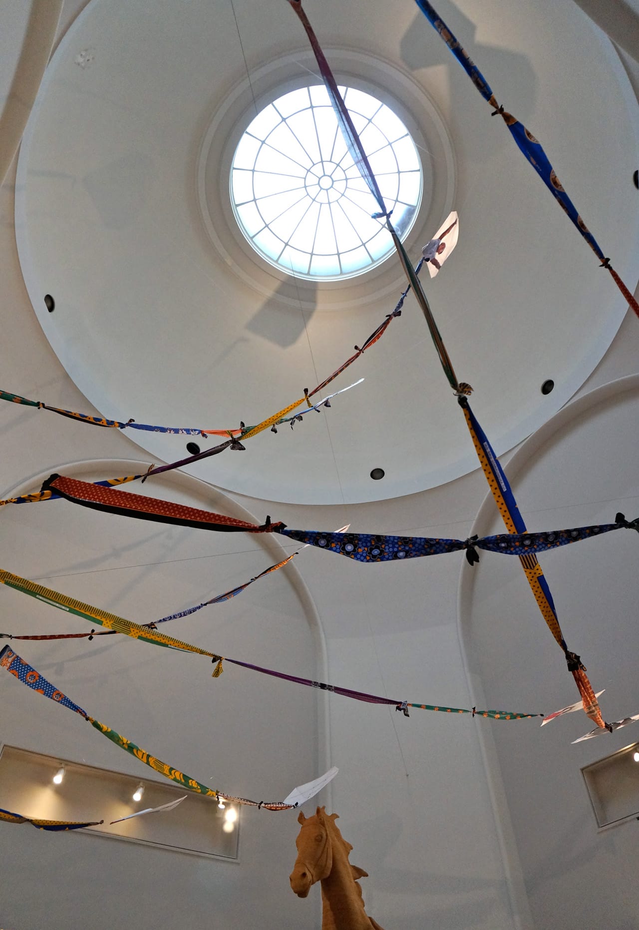 Atrium skylight with Miguel Luciano's "Amani Kites" (2012–14) and part of Jonas's "The Commons"