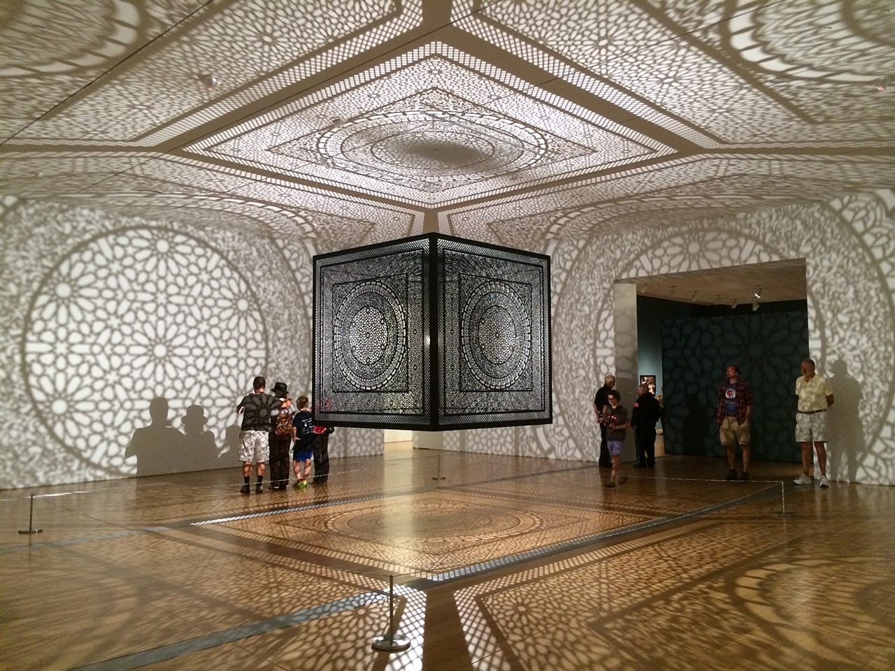 ArtPrize visitors in the gallery with Anila Quayyum Agha's "Intersections" at the Grand Rapids Art Museum