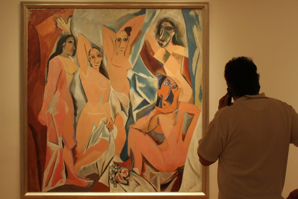 Man listening to an audio guide in front of Picasso's "Les Demoiselles d'Avignon" (photo by peteaylward/Flickr.com)