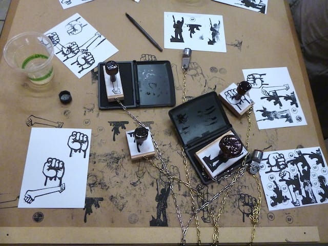 A side table next to Taraneh Hemami's souvenir shop includes rubber stamps with iconography for visitors to place on cards or any other objects they bring.