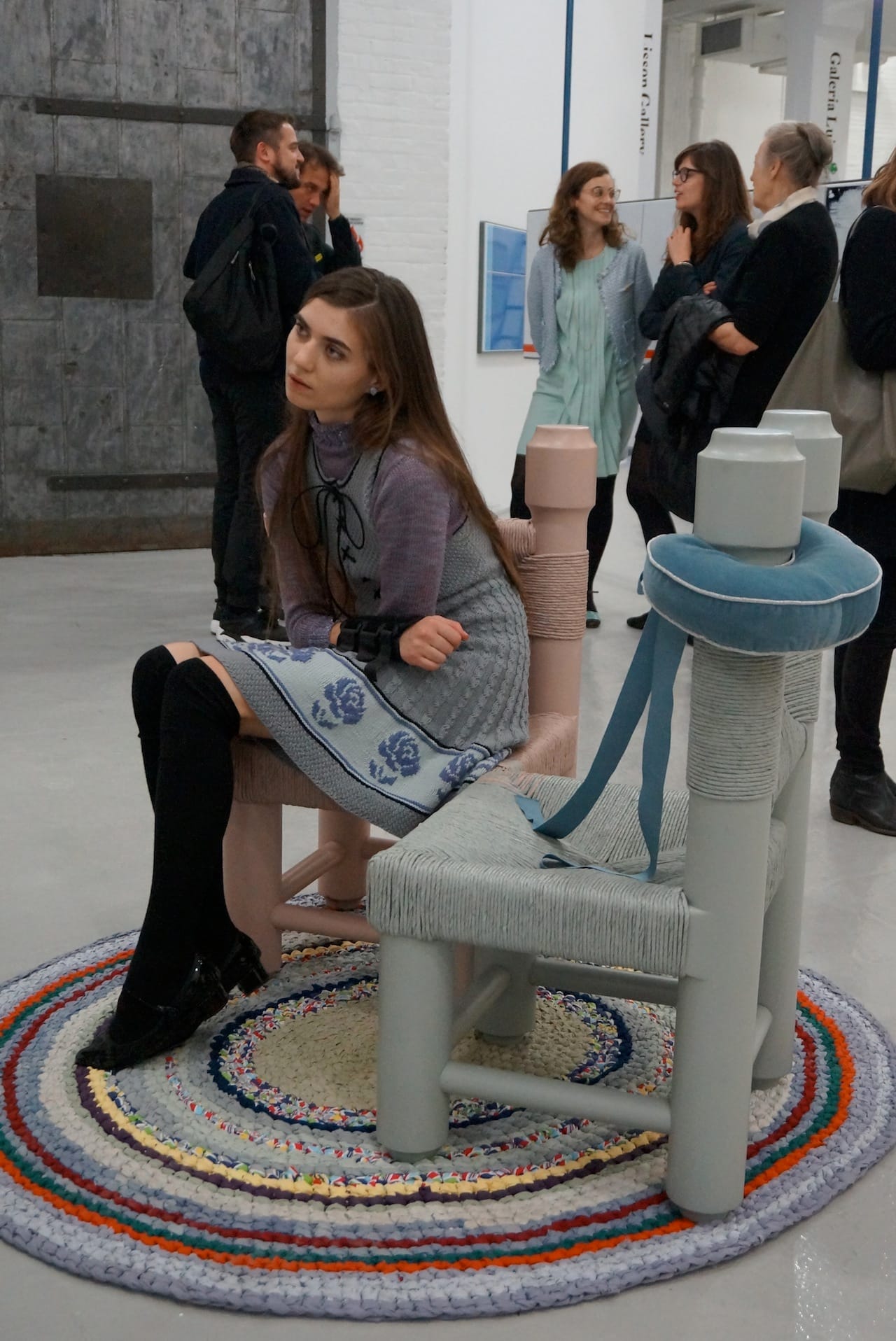 A woman rests on a chair by Bunny Rogers, at Société.
