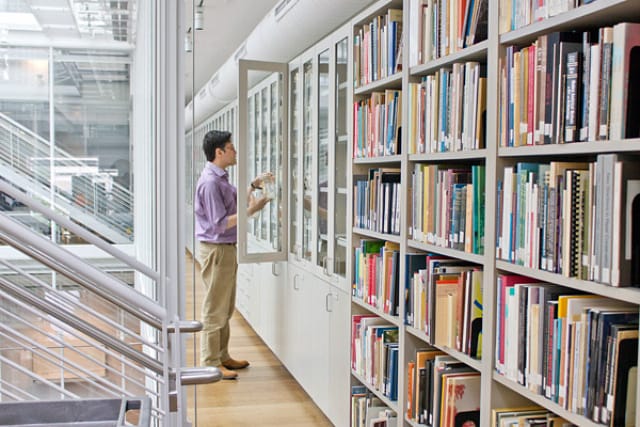 Narayan Khandekar, senior conservation scientist at the Harvard Art Museums, installs the pigment collection in the Straus Center for Conservation and Technical Studies. Photo: Antoinette Hocbo. 