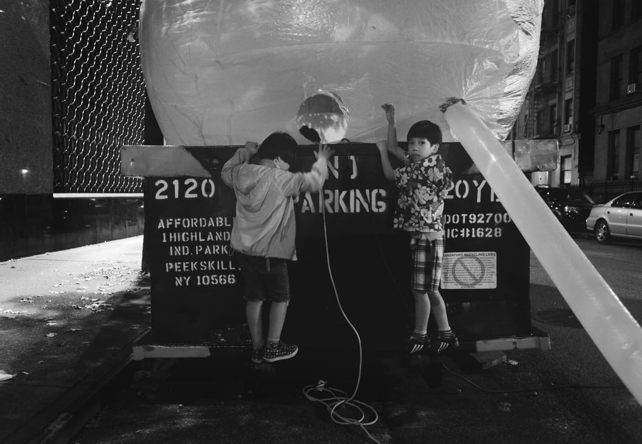 Kids outside the Inflato Dumpster