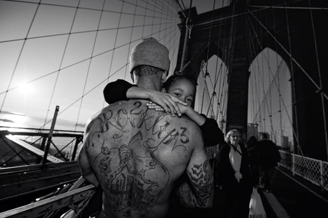Jerell Williams carrying Fidel on the Brooklyn Bridge