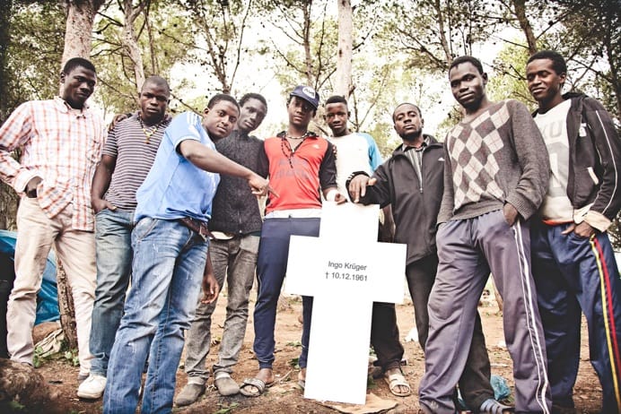 Migrants in Melilla pose with one of the crosses (Image courtesy of the Center for Political Beauty)