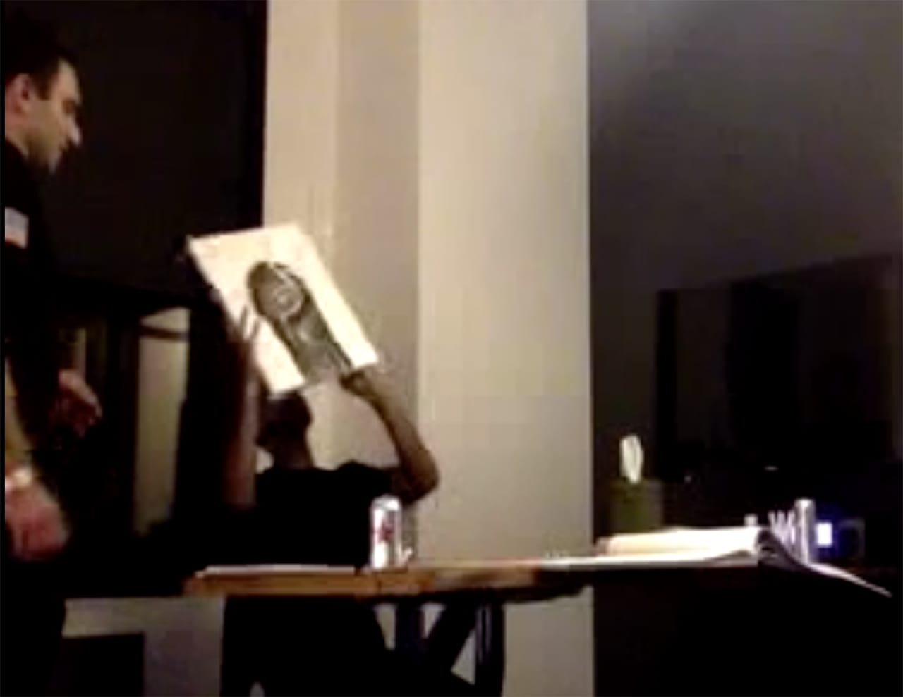 Jay signing the back of his "ART WHORE" canvas (screenshot by the author, via ryder-ripps.com)