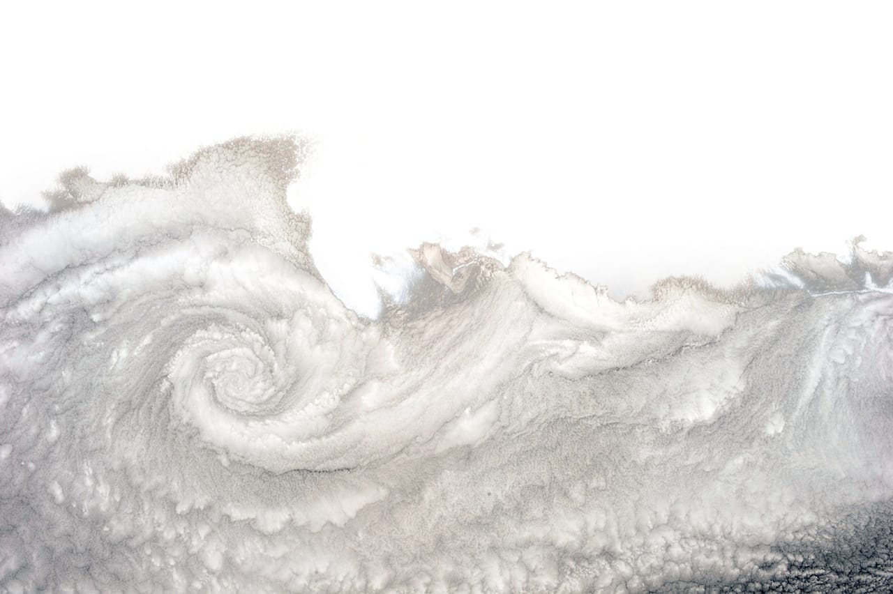 A cloud twist over Arica, Chile. Hadfield writes: "You see these frequently in this part of the world because the Pacific is cold, the land is warm, and the currents and winds combine to form a cloudy vortex—clockwise here, because it’s the southern hemisphere. North of the equator, the spiral would turn counter-clockwise."  (photograph by Chris Hadfield/NASA)